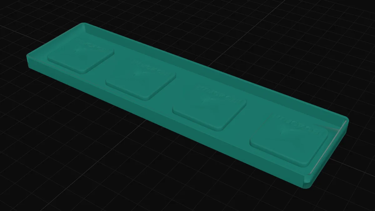 An open-top silicone mould box with a row of rectangular fridge magnets raised inside it
